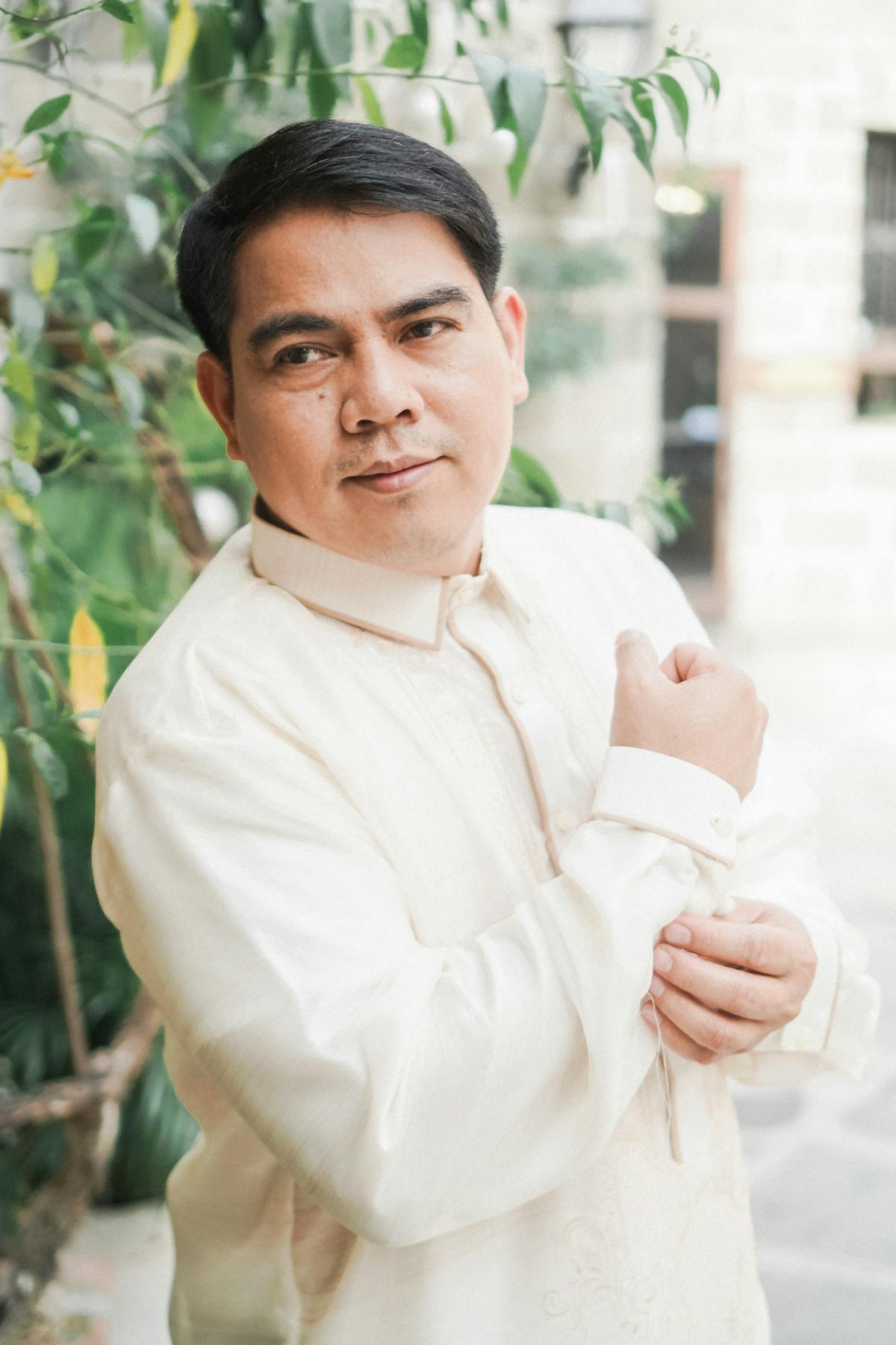 A Filipino professional in a barong tagalog, composed and looking ahead.
