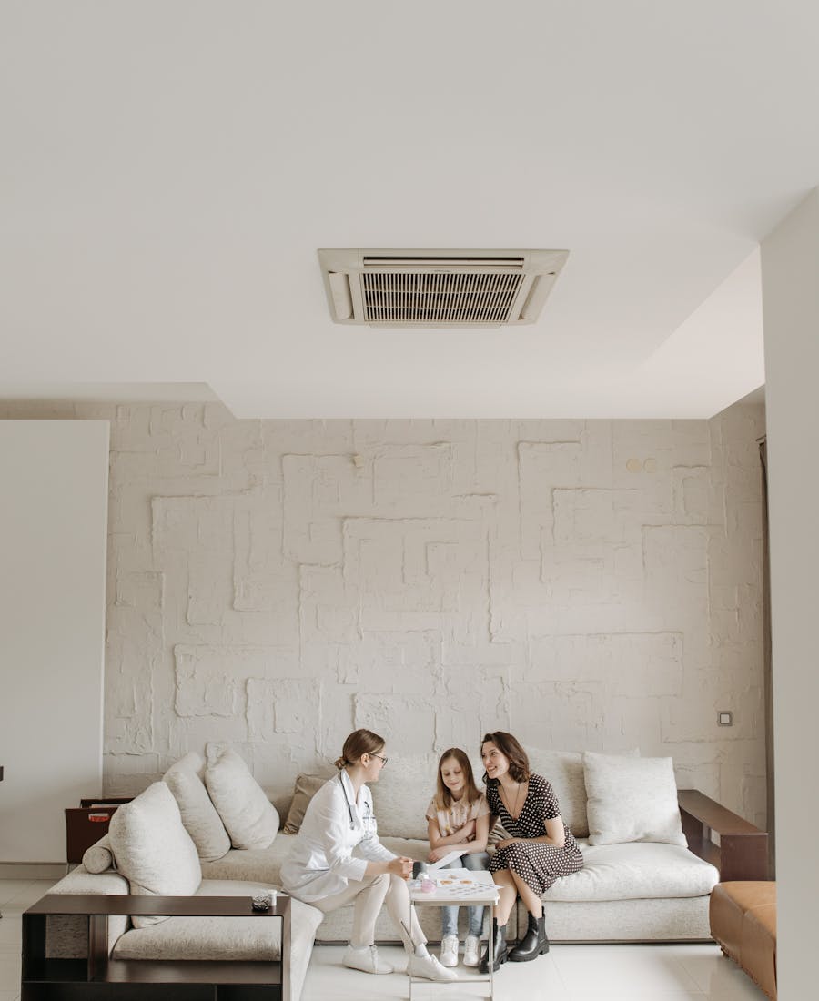 A mother and daughter in a warm consultation with a doctor at home.