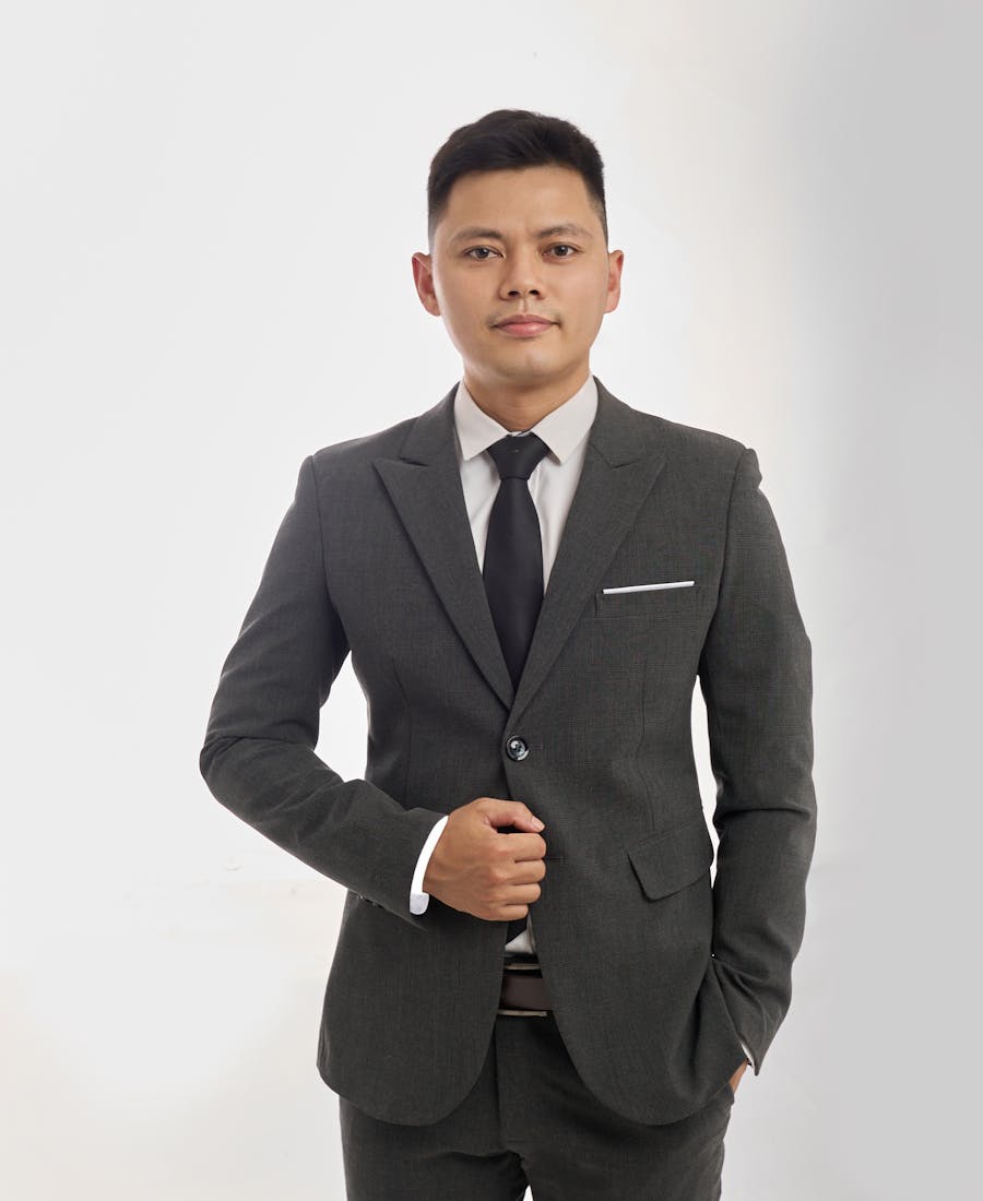 A young Filipino professional in formal attire, confident and composed.